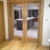 pair of oak internal doors with frame and grey tint glass